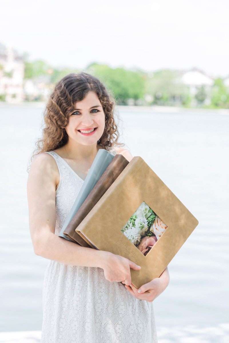 A pair of linen-bound wedding albums open on a table